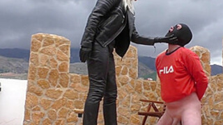 Ballbusting CFNM domina in leather kicks sub outdoor