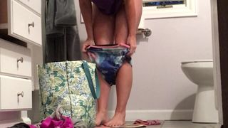 Squeezing into her swimsuit