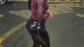 Hot african whore with wetlook leather leggings showing butt